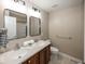 Bathroom featuring double sinks with mirrors and neutral paint at 11648 Stickney Ct, Fishers, IN 46037
