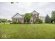 Charming brick two-story home with a well-manicured lawn and mature landscaping at 11648 Stickney Ct, Fishers, IN 46037