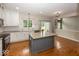 Well-lit kitchen featuring a kitchen island, white cabinetry, and stainless steel appliances at 11648 Stickney Ct, Fishers, IN 46037