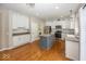 Updated kitchen with stainless steel appliances, granite counters, tile backsplash, and hardwood floors at 11648 Stickney Ct, Fishers, IN 46037
