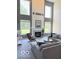Bright living room boasts many windows, fireplace, and neutral decor with a large couch at 11648 Stickney Ct, Fishers, IN 46037