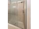 Shower featuring a sliding glass door and tiled walls with a shower head and shelving at 11648 Stickney Ct, Fishers, IN 46037