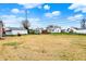 Backyard with a detached garage and a glimpse of a deck, all surrounded by a spacious grassy area at 1194 S Faculty Dr, Indianapolis, IN 46241