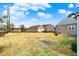 Spacious backyard with ample space, featuring a stone-clad home and additional garage at 1194 S Faculty Dr, Indianapolis, IN 46241