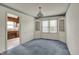 Dining room with built-in cabinets, large windows, and blue carpet at 1194 S Faculty Dr, Indianapolis, IN 46241