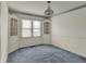 Dining room featuring built-in cabinets, large windows, and blue carpet at 1194 S Faculty Dr, Indianapolis, IN 46241