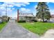 Charming stone-clad home featuring a detached garage and driveway in a residential neighborhood at 1194 S Faculty Dr, Indianapolis, IN 46241