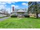 Charming stone-clad home with a well-maintained lawn and mature tree in a residential neighborhood at 1194 S Faculty Dr, Indianapolis, IN 46241