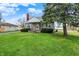 Charming stone-clad home with a well-maintained lawn and mature tree in a residential neighborhood at 1194 S Faculty Dr, Indianapolis, IN 46241
