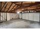 Spacious garage featuring an unfinished ceiling, concrete flooring, and white door at 1194 S Faculty Dr, Indianapolis, IN 46241