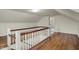 Hallway with wood floors and white railings, leading to another room with a doorway at 1194 S Faculty Dr, Indianapolis, IN 46241