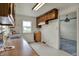 Bright kitchen featuring wood cabinets, white tiled floor, and plenty of natural light at 1194 S Faculty Dr, Indianapolis, IN 46241