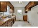 The kitchen featuring wood cabinets, stainless steel sink, and white tile flooring at 1194 S Faculty Dr, Indianapolis, IN 46241