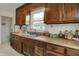 Kitchen with wood cabinetry, stainless steel sink, and plenty of counter space at 1194 S Faculty Dr, Indianapolis, IN 46241