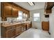 Traditional kitchen with wood cabinets, ample counter space, and a white tiled floor at 1194 S Faculty Dr, Indianapolis, IN 46241