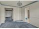 An empty living room shows the space in the home, featuring blue carpet and light-colored walls at 1194 S Faculty Dr, Indianapolis, IN 46241