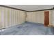 Spacious living room featuring patterned wallpaper and blue carpet at 1194 S Faculty Dr, Indianapolis, IN 46241