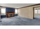 Spacious living room with blue carpet, patterned wallpaper, and a brick fireplace at 1194 S Faculty Dr, Indianapolis, IN 46241