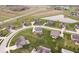 Aerial view of the real estate showcasing a well-manicured neighborhood, nearby pond, and green spaces at 1243 Colinbrook Cir, Greenwood, IN 46143