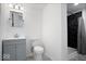 Modern bathroom with gray vanity, step-in shower, and black marble tile at 1243 Colinbrook Cir, Greenwood, IN 46143