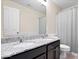 Bathroom featuring a dual sink vanity with granite countertops, modern fixtures, and a neutral color scheme at 1243 Colinbrook Cir, Greenwood, IN 46143