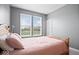 Cozy bedroom with a wooden bed frame, plush bedding, and a view of the outdoors at 1243 Colinbrook Cir, Greenwood, IN 46143