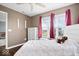 Inviting bedroom with a comfortable bed, large windows, and warm, neutral wall color at 1243 Colinbrook Cir, Greenwood, IN 46143
