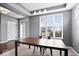 Open dining room featuring tray ceilings, large windows, and modern lighting, perfect for entertaining at 1243 Colinbrook Cir, Greenwood, IN 46143