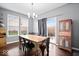 Bright dining room featuring wood table, stylish light fixture, and access to the outdoor deck at 1243 Colinbrook Cir, Greenwood, IN 46143
