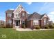 Beautiful two-story brick home features a manicured lawn and inviting entrance, showcasing classic architectural details at 1243 Colinbrook Cir, Greenwood, IN 46143