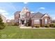 Charming two-story brick home features manicured front lawn and detailed architectural elements, offering great curb appeal at 1243 Colinbrook Cir, Greenwood, IN 46143