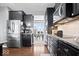 Modern kitchen features stainless steel appliances, dark cabinets, and a breakfast bar with an open dining area at 1243 Colinbrook Cir, Greenwood, IN 46143