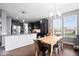 Spacious kitchen area with dark cabinets, granite countertops, and a wooden dining table set near ample natural light at 1243 Colinbrook Cir, Greenwood, IN 46143