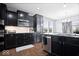 Modern kitchen design featuring dark cabinetry, stainless steel appliances, and granite countertops for a sleek and functional space at 1243 Colinbrook Cir, Greenwood, IN 46143