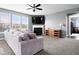 Spacious living room with a fireplace, plush sofa, and lots of natural light creates a cozy and inviting atmosphere at 1243 Colinbrook Cir, Greenwood, IN 46143