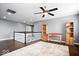 Open loft area with hardwood floors, neutral walls, and staircase with white railings at 1243 Colinbrook Cir, Greenwood, IN 46143