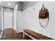 Welcoming mudroom featuring coat hooks, a bench, and wood-look flooring, perfect for organization at 1243 Colinbrook Cir, Greenwood, IN 46143