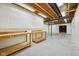 Unfinished basement features workbench, open ceiling and concrete floors ready for customization at 12907 Shiraz Ln, Fishers, IN 46037