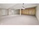 Finished basement with wood accent wall, neutral carpet, and ample open space at 12907 Shiraz Ln, Fishers, IN 46037