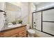 The functional bathroom offers an extended vanity and a tub-shower combo with a glass door at 12907 Shiraz Ln, Fishers, IN 46037