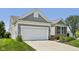 Charming home exterior with a two-car garage, manicured lawn and attractive landscaping at 12907 Shiraz Ln, Fishers, IN 46037