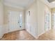 Bright foyer with tiled floor, white trim and panelling, and a white front door at 12907 Shiraz Ln, Fishers, IN 46037