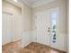 Bright foyer with tiled floor, white trim and panelling, and a white front door at 12907 Shiraz Ln, Fishers, IN 46037