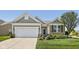 Charming home with landscaped front yard, two-car garage, and a welcoming entrance at 12907 Shiraz Ln, Fishers, IN 46037
