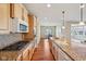 Modern kitchen with granite countertops, stainless steel appliances, and hardwood floors at 12907 Shiraz Ln, Fishers, IN 46037