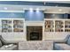 A cozy library featuring built-in bookshelves, a fireplace and comfortable seating at 12907 Shiraz Ln, Fishers, IN 46037