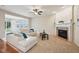 Bright living room with fireplace, hardwood floors, and plenty of natural light at 12907 Shiraz Ln, Fishers, IN 46037