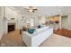 Open-concept living room with fireplace and hardwood floors, open to the kitchen at 12907 Shiraz Ln, Fishers, IN 46037