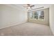 Spacious main bedroom features carpeted floors, a ceiling fan, and natural light from the windows at 12907 Shiraz Ln, Fishers, IN 46037