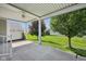 Covered outdoor patio with view of lawn and trees at 12907 Shiraz Ln, Fishers, IN 46037